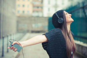 young beautiful brunette woman girl listening music headphones outdoor
